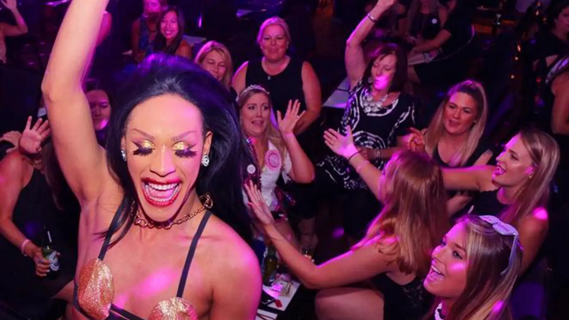 Drag queen performing on stage.