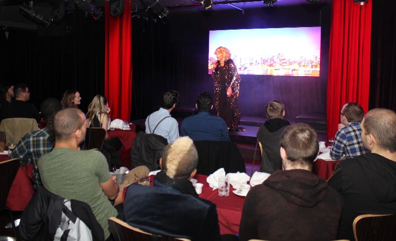 a group of people sitting on a stage in front of a crowd