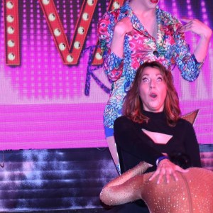 a woman sitting on a stage