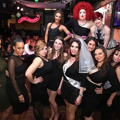 a group of people standing in front of a crowd posing for the camera